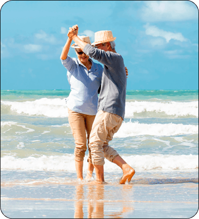 Retired couple dancing on the beach